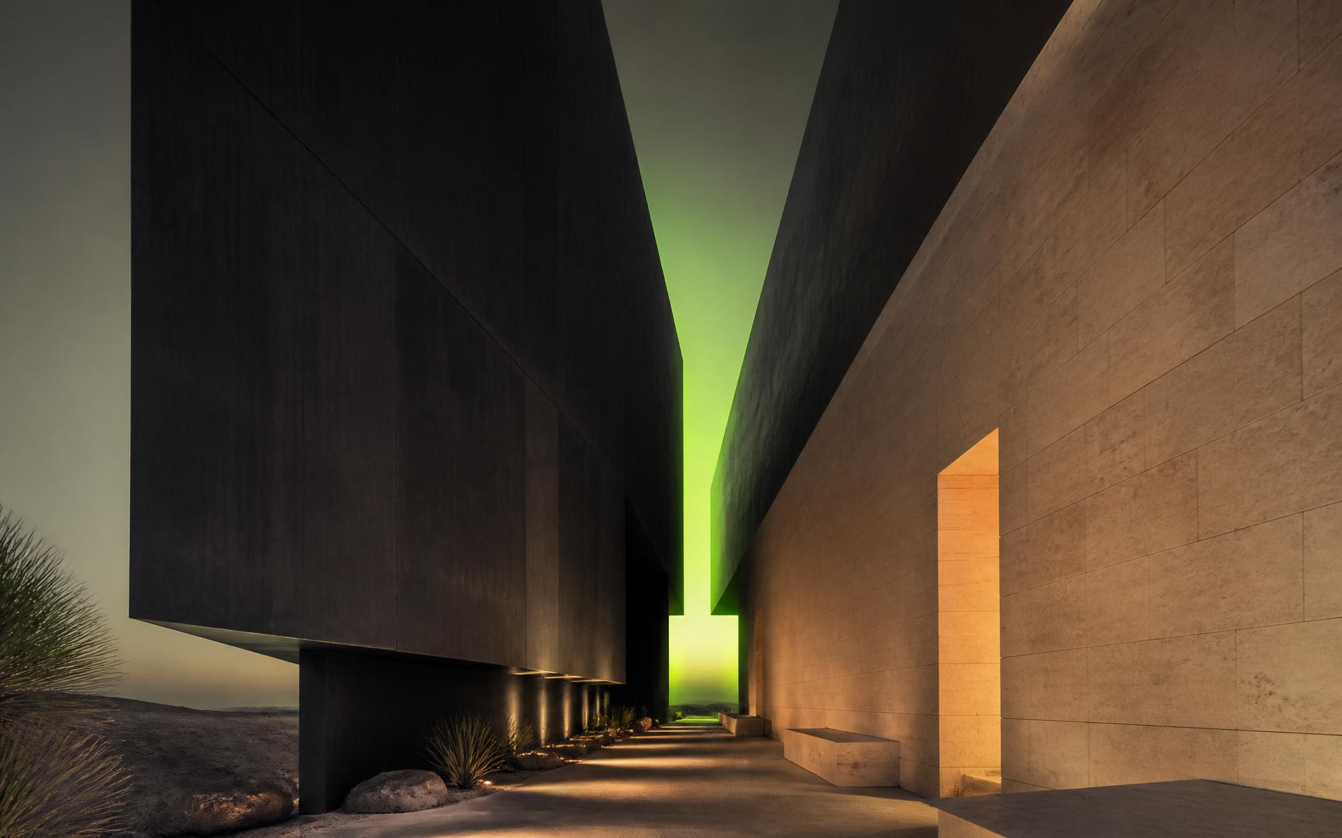 Dark concrete corridor meeting warm bone-toned limestone with a lime aperture of light.